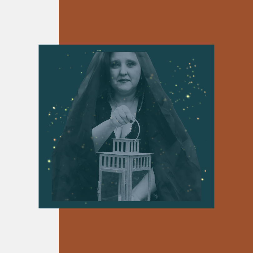 woman in black head covering holding lantern