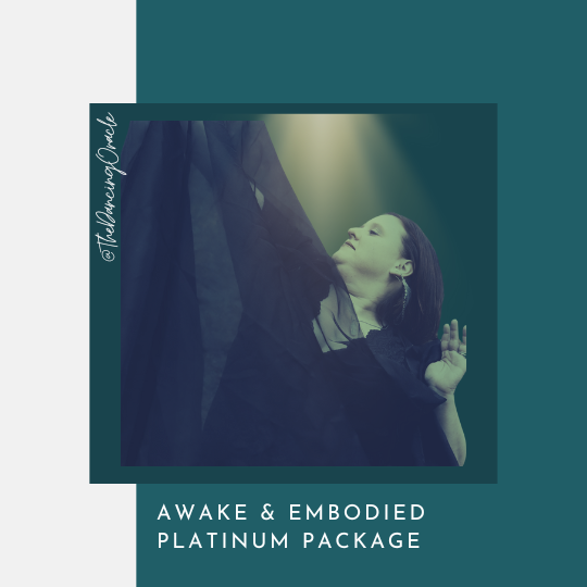 woman holding black scarf lifting one arm to the sky